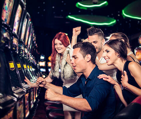 Group of people playing slot machines