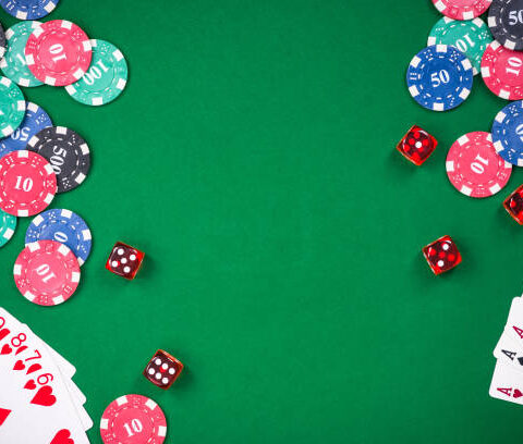 Casino games related items on green table, copy space.