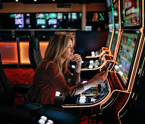 Women gambling on slot machinery