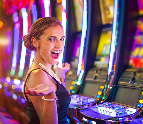 Young woman playing slot machines at the Casino